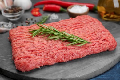 Raw fresh minced meat with rosemary, closeup