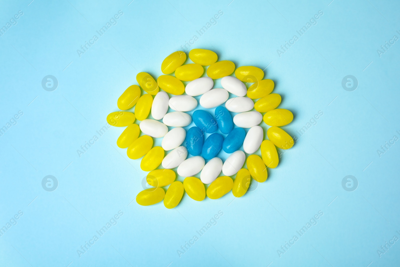 Photo of Delicious jelly beans on color background, top view