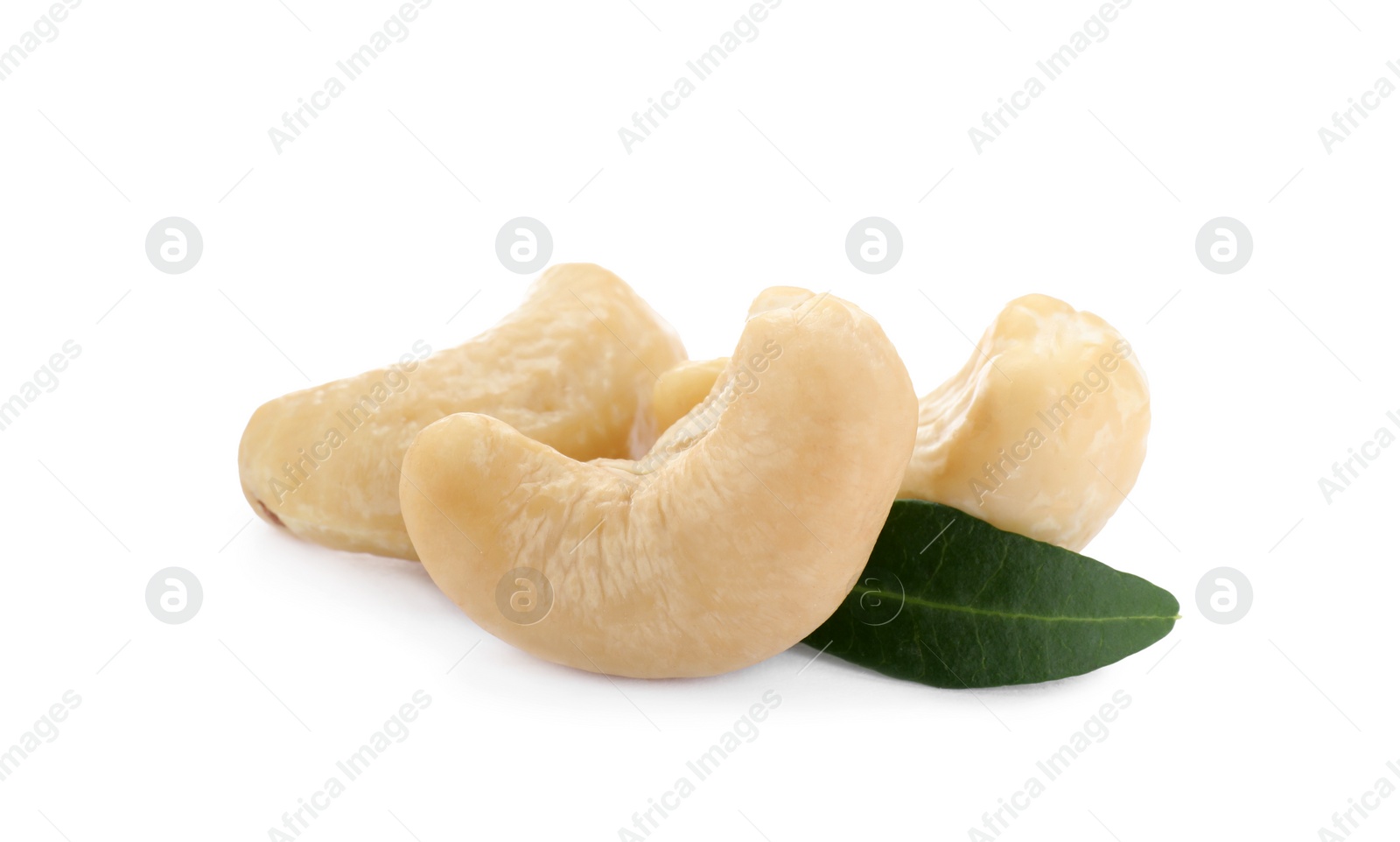 Photo of Tasty organic cashew nuts and green leaf isolated on white