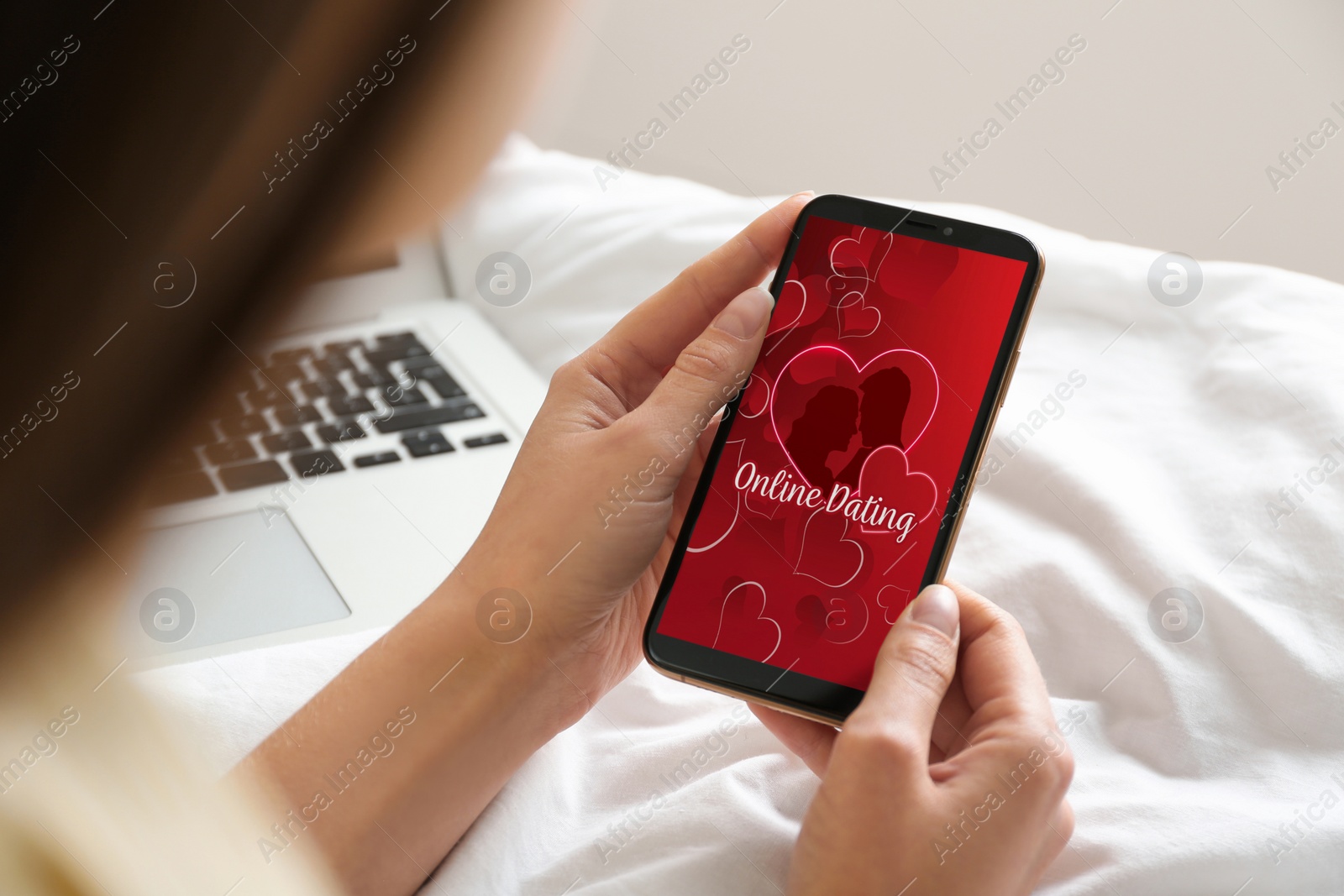 Image of Woman visiting dating site via smartphone indoors, closeup