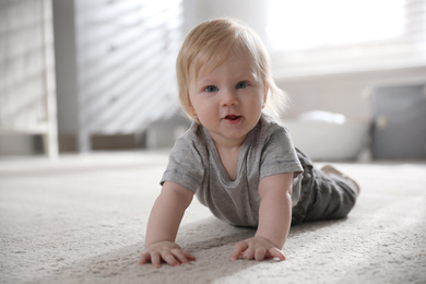 Adorable little baby on floor at home