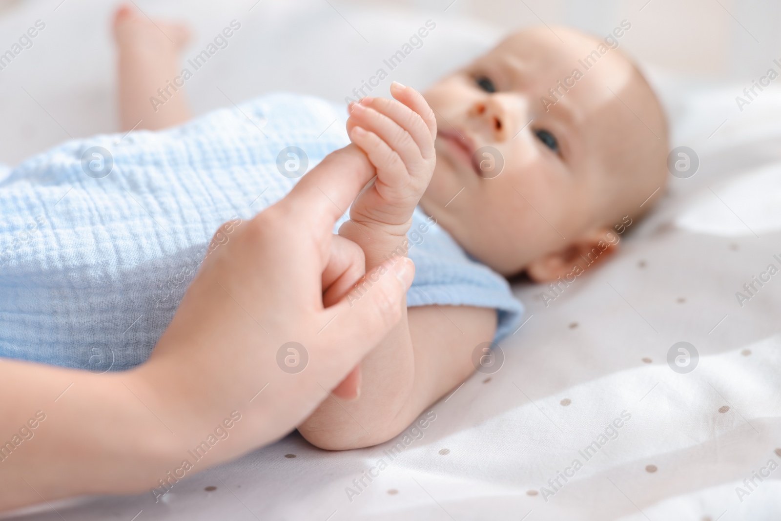 Photo of Mother with her cute little baby in crib, selective focus