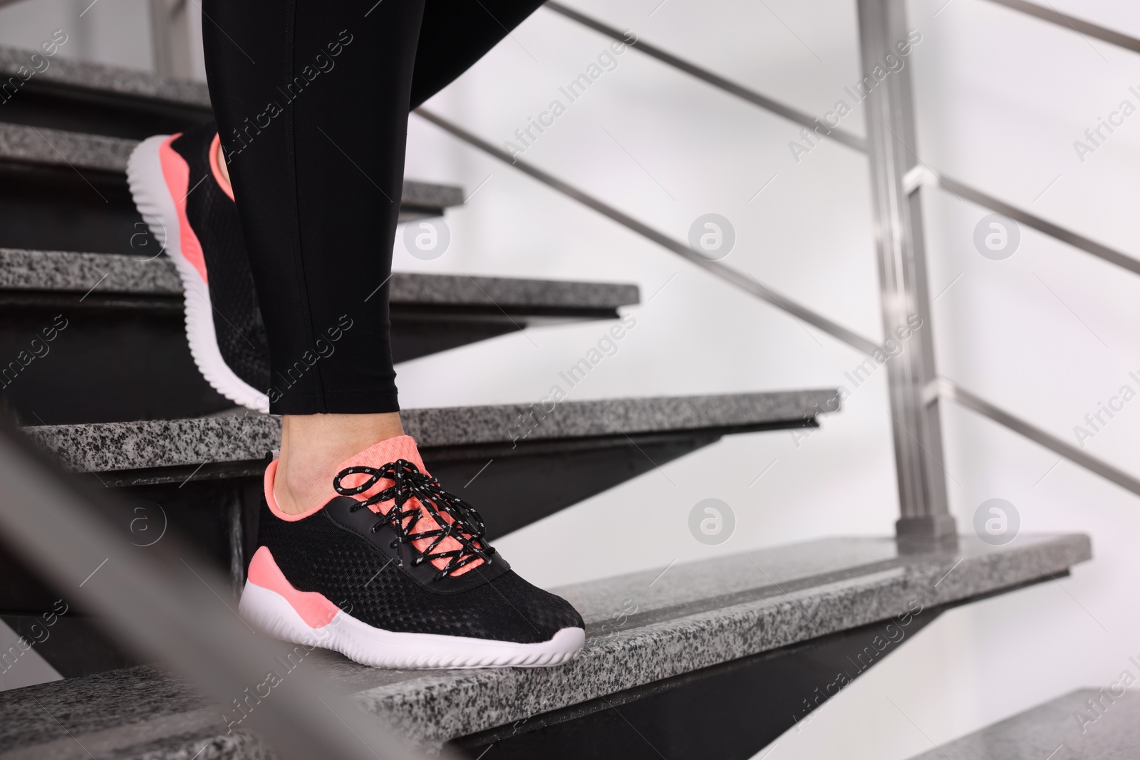 Photo of Overweight woman running downstairs indoors, closeup. Space for text