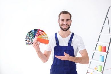Photo of Male decorator with color palette on white background