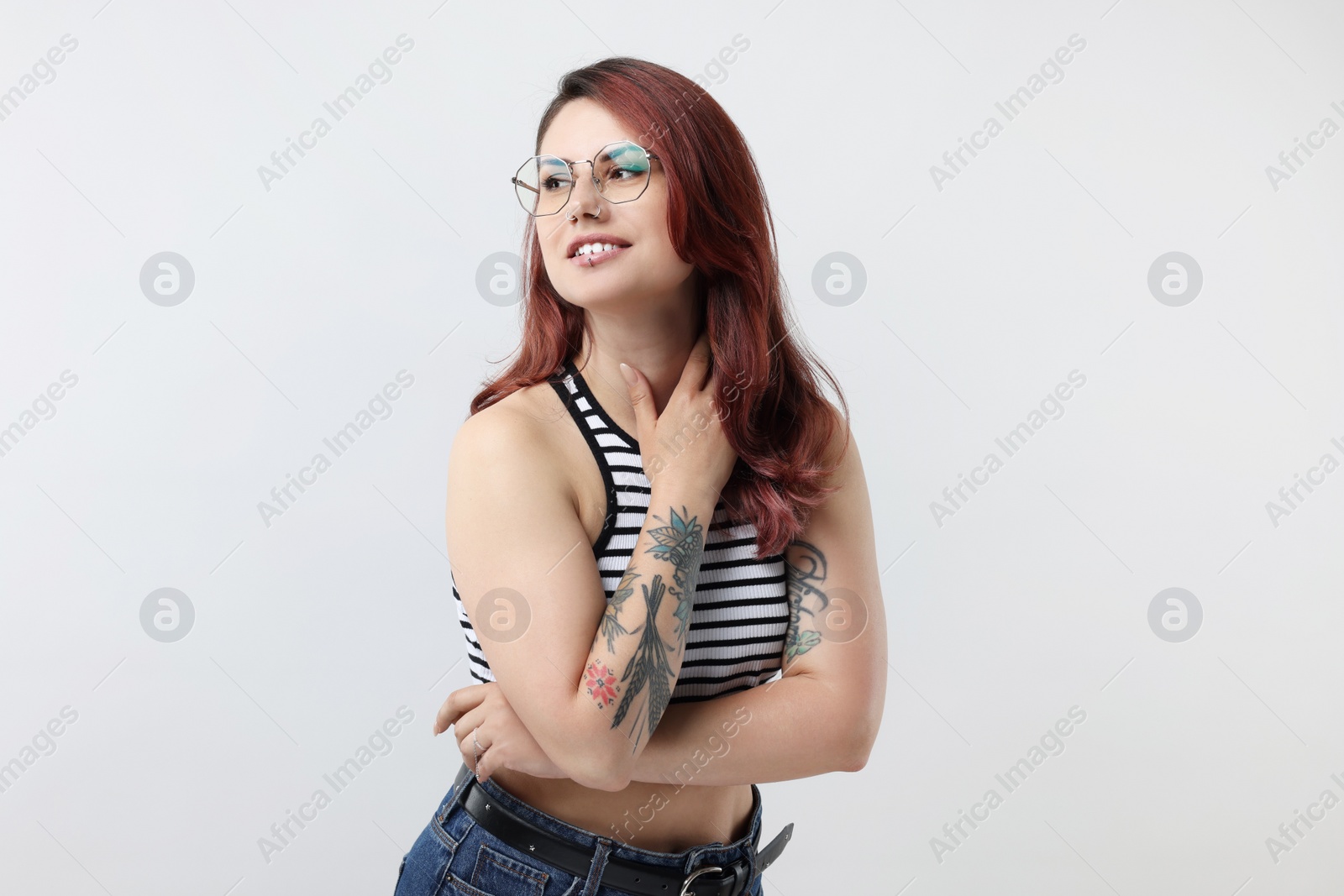 Photo of Portrait of beautiful tattooed woman on gray background