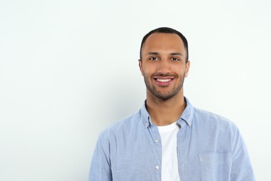 Photo of Portrait of handsome young man on white background, space for text