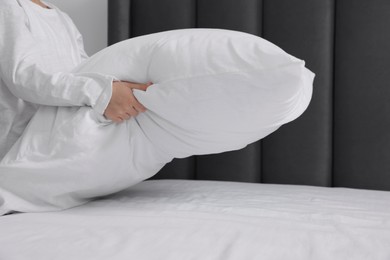 Photo of Girl changing bed linens in bedroom, closeup