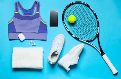 Photo of Stylish sportswear and equipment on light blue background, flat lay