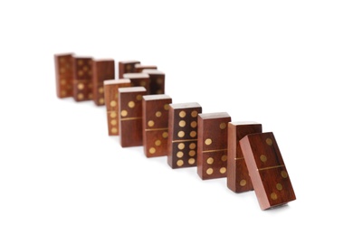 Photo of Wooden domino tiles falling on white background