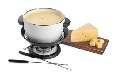 Photo of Fondue with tasty melted cheese, forks and pieces isolated on white