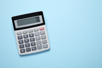 Calculator on light blue background, top view. Space for text