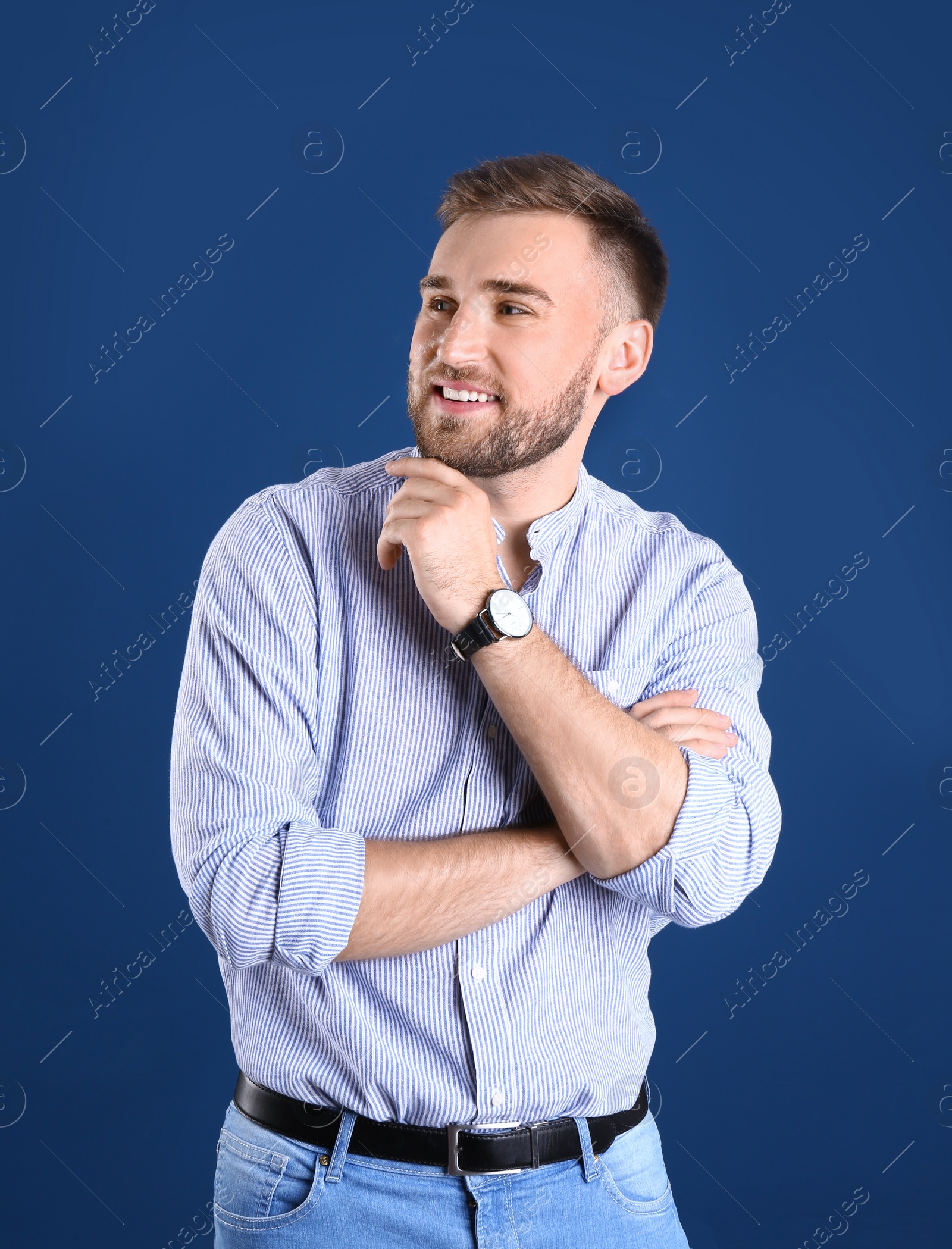 Photo of Portrait of handsome happy man on color background