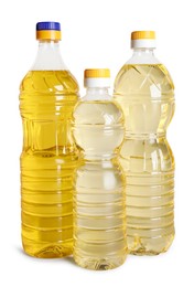 Photo of Bottles of cooking oil on white background