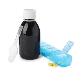 Bottle of syrup, plastic spoon with pills on white background. Cough and cold medicine