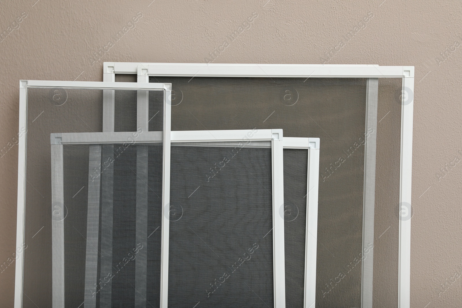 Photo of Set of window screens near beige wall