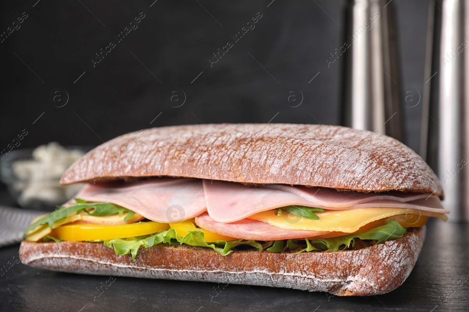 Photo of Tasty sandwich with ham on black table, closeup