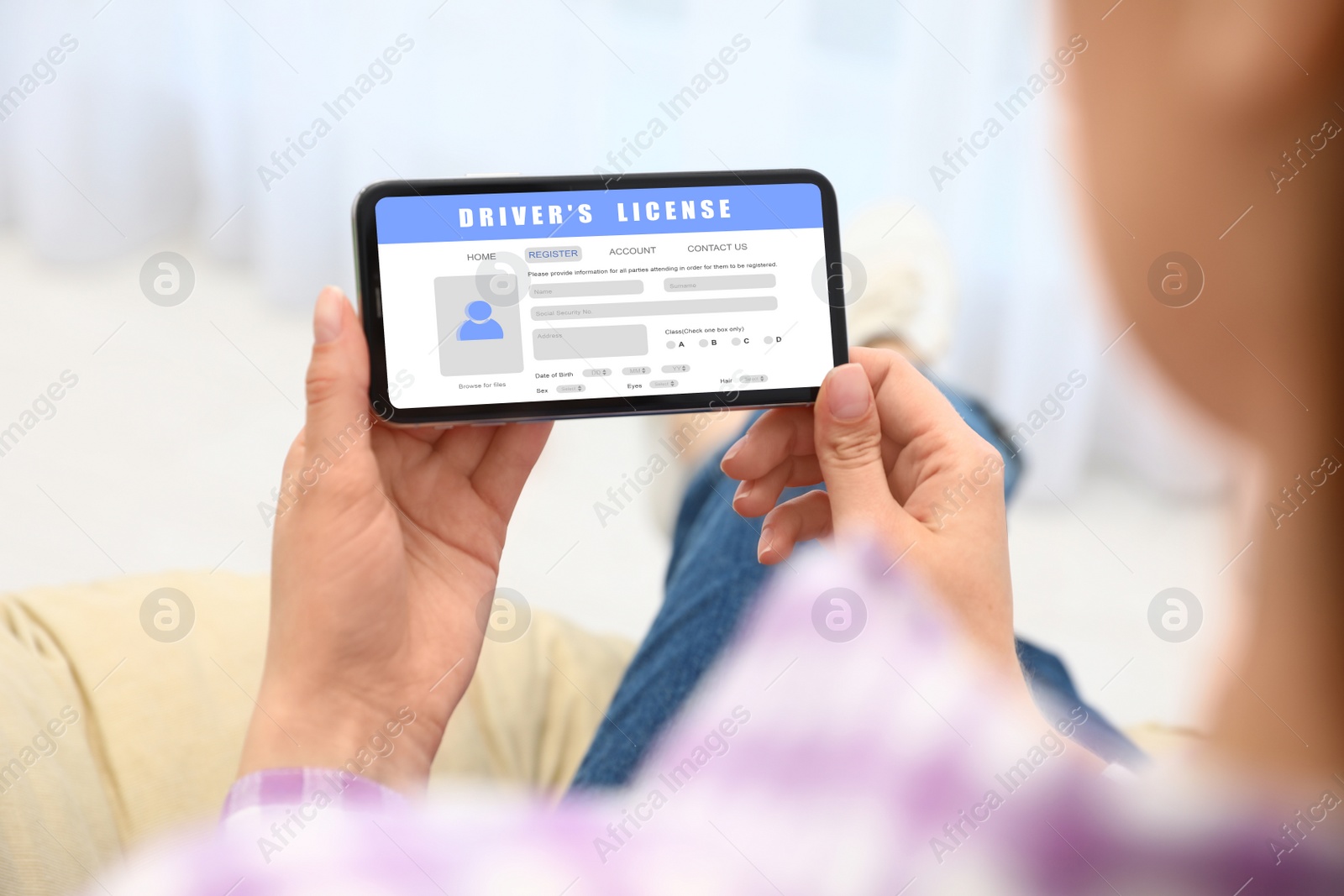 Image of Woman filling in driver's license form online on website using smartphone, closeup