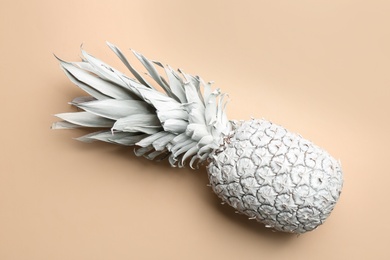 White pineapple on beige background, top view. Creative concept