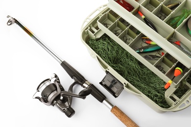 Photo of Box with tackle and fishing rod on white background