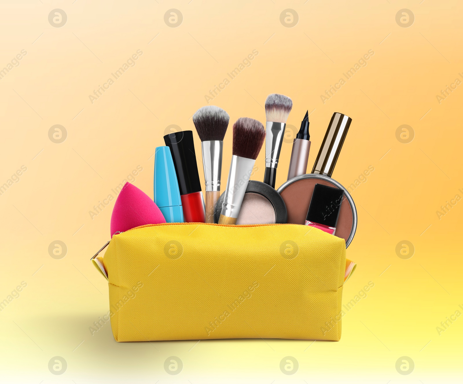 Image of Cosmetic bag filled with makeup products on color gradient background