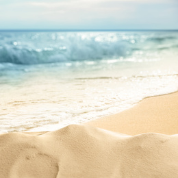 Image of Ocean waves rolling on sandy beach, closeup view