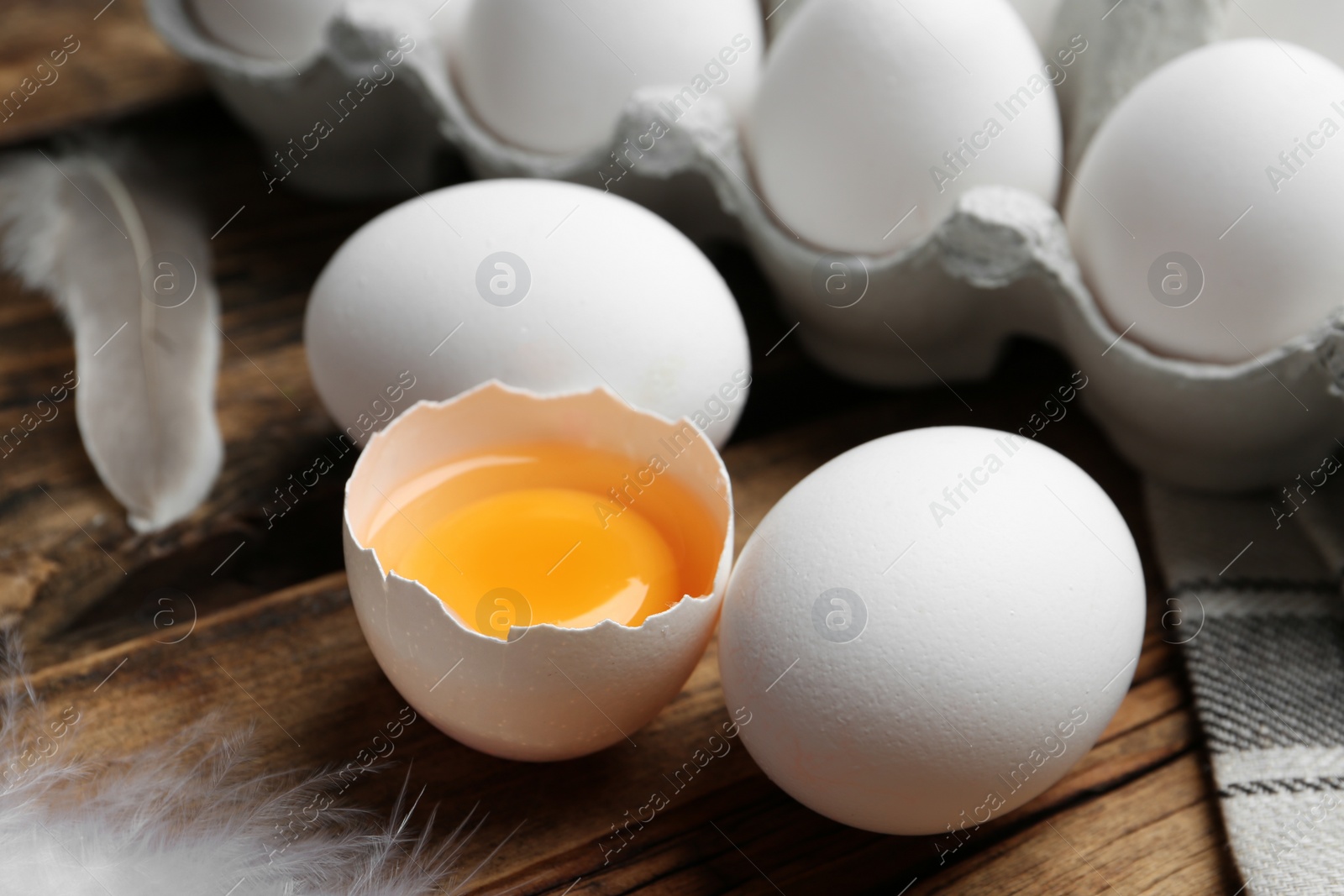 Photo of Fresh raw chicken eggs on wooden table, closeup