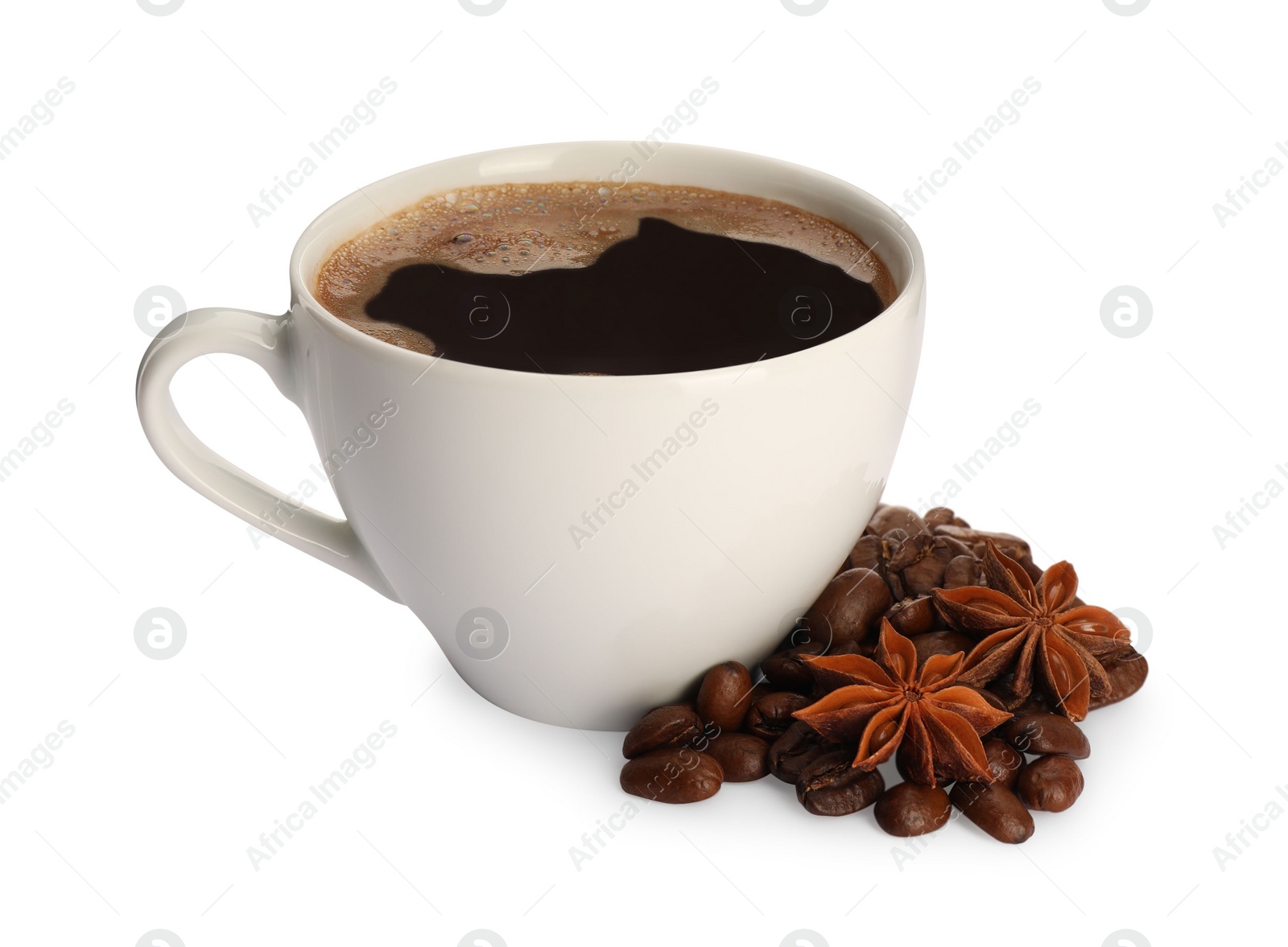 Photo of Cup of aromatic coffee with anise stars and beans on white background