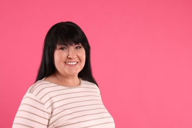 Photo of Beautiful overweight mature woman with charming smile on pink background. Space for text