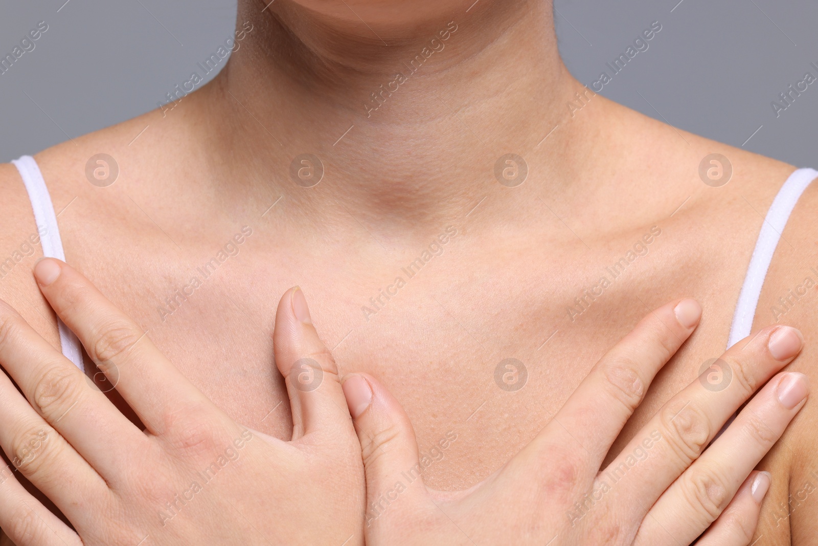 Photo of Closeup view of woman with normal skin on grey background