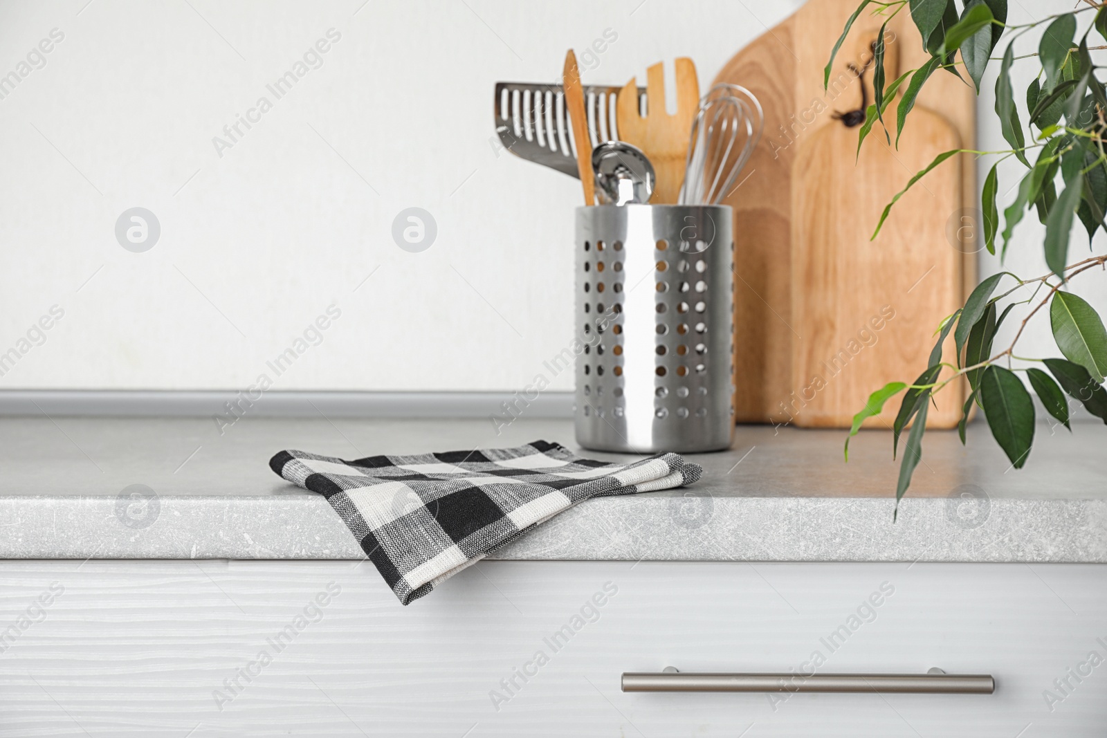 Photo of Fabric checkered towel on table in kitchen