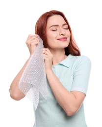 Woman popping bubble wrap on white background. Stress relief