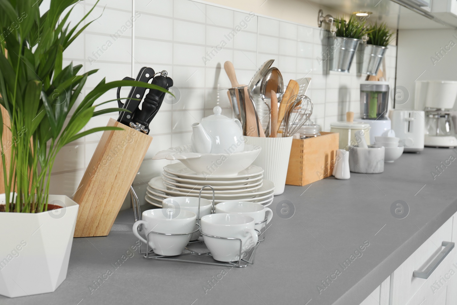 Photo of Clean dishes and utensils on kitchen counter