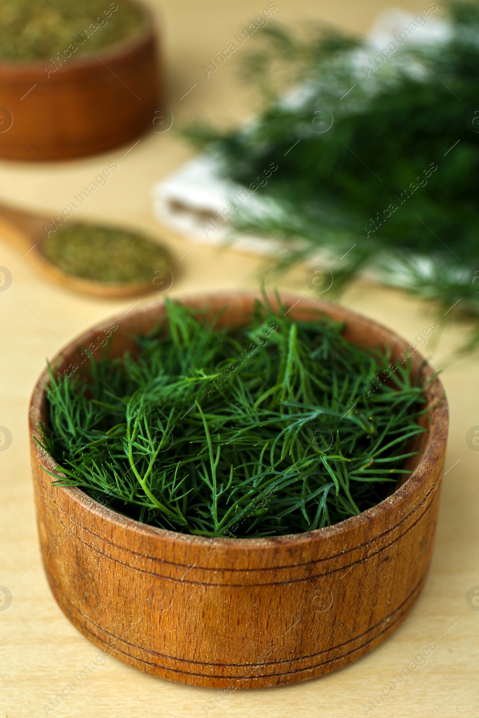 Photo of Bowl of fresh dill on wooden table