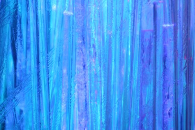 Photo of Optical fiber strands transmitting blue light, macro view