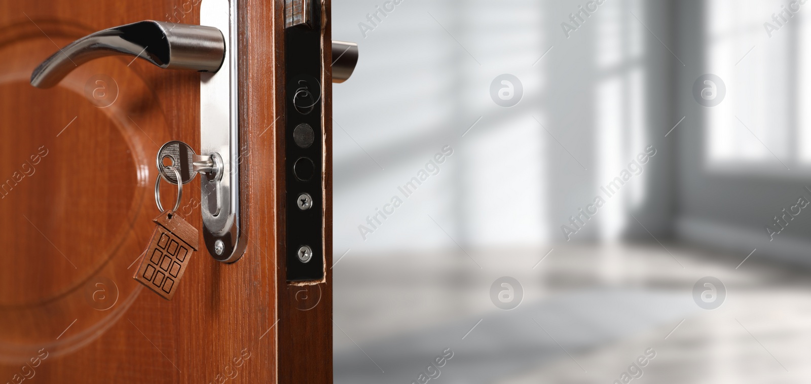 Image of Closeup view of door with key open into empty room