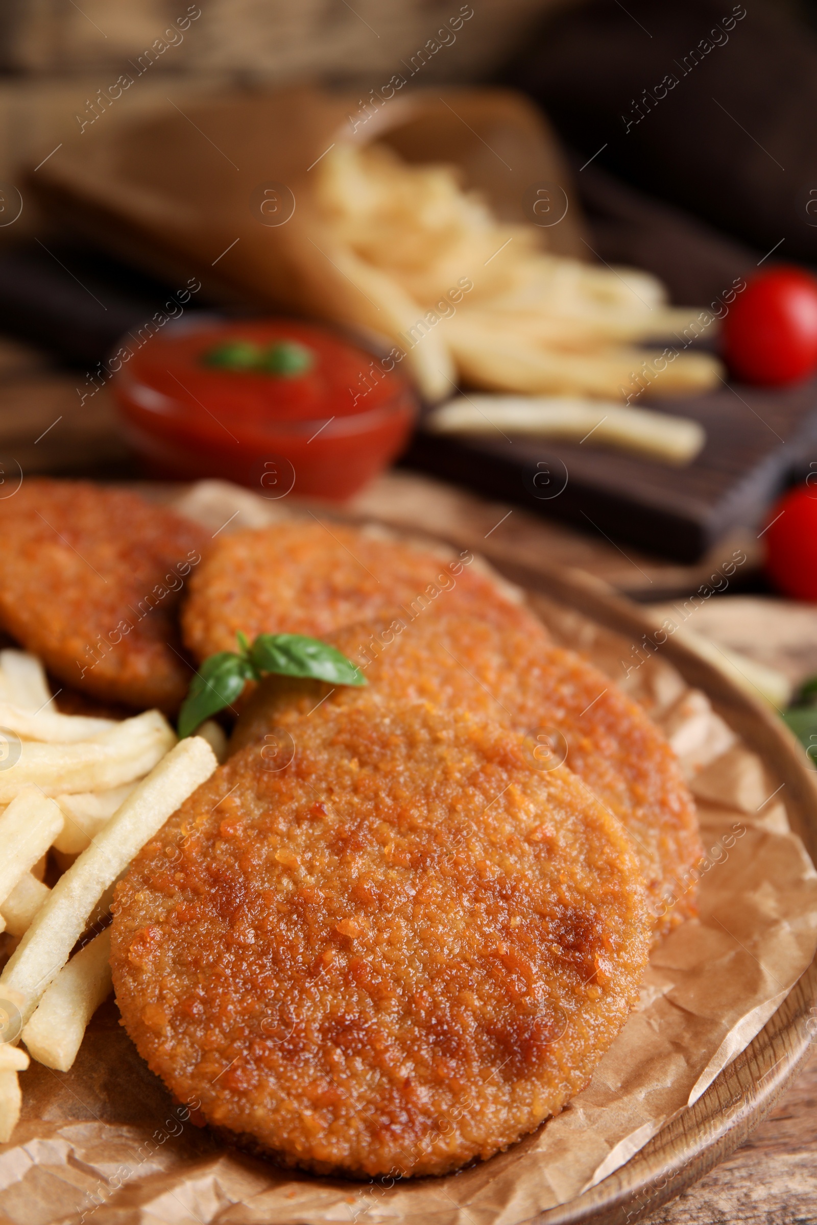 Photo of Delicious fried breaded cutlets served on wooden table, closeup