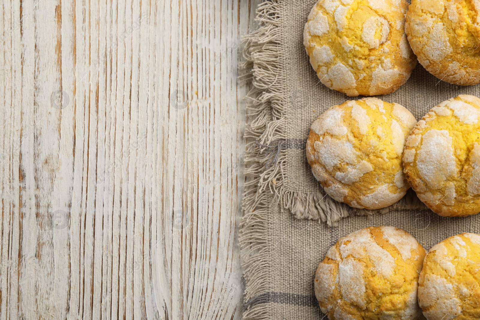 Photo of Delicious lemon cookies on wooden table, flat lay. Space for text