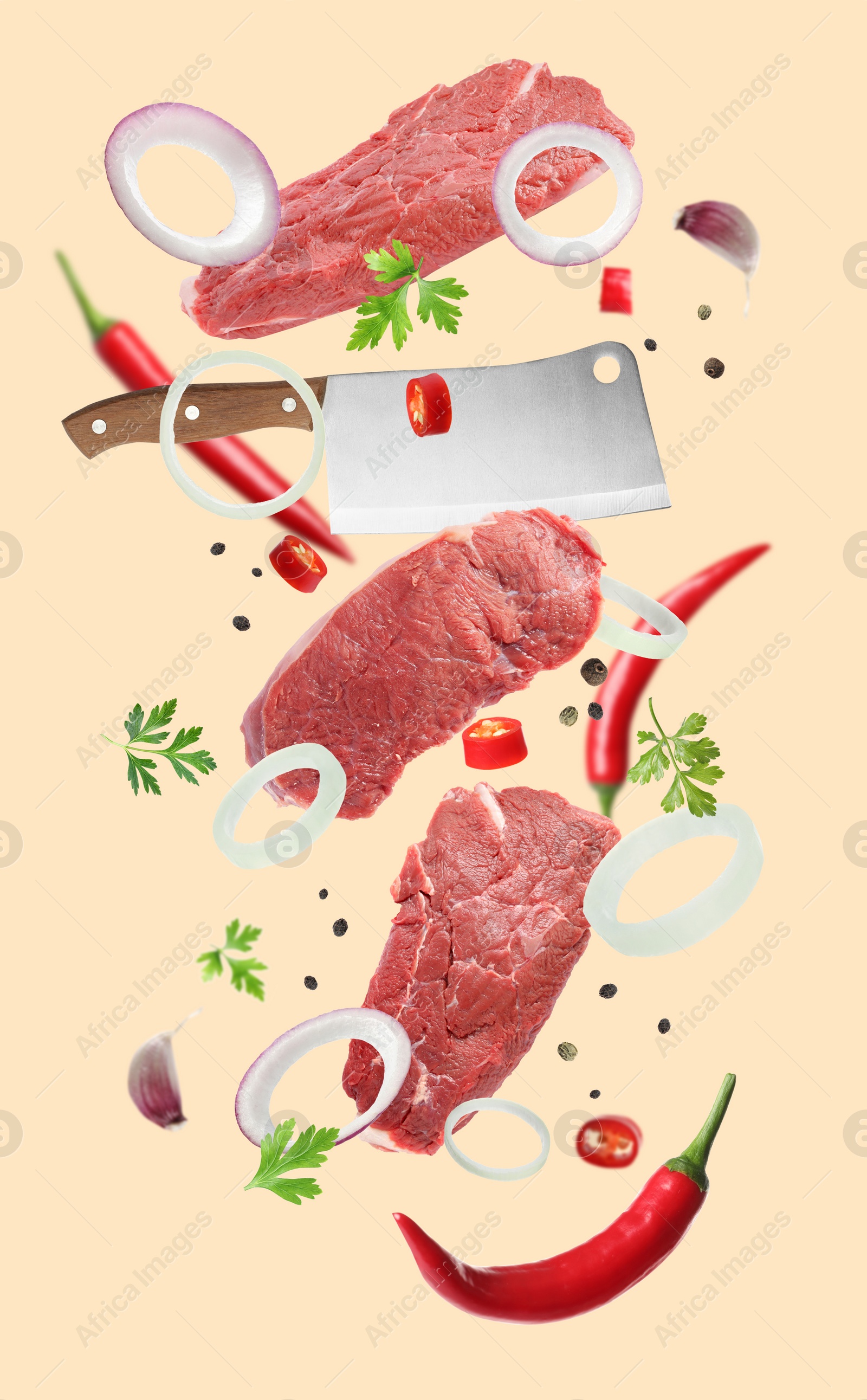 Image of Beef meat, different spices and cleaver knife falling on beige background