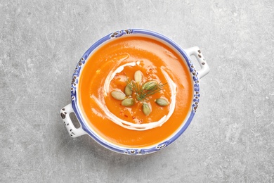 Photo of Bowl of tasty sweet potato soup on table, top view