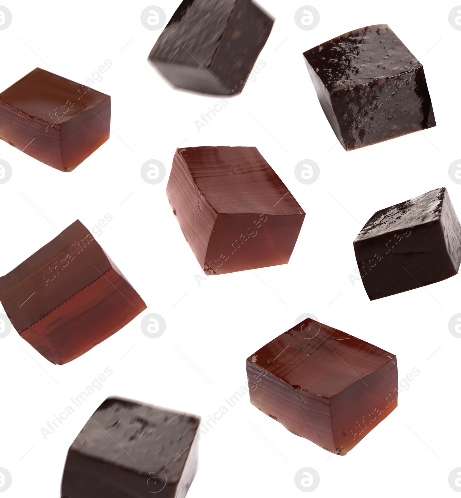 Image of Tasty grass jelly cubes falling on white background