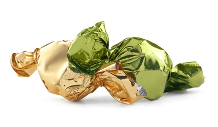 Photo of Candies in green and golden wrappers isolated on white