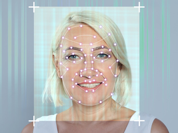 Image of Facial recognition system. Mature woman with digital biometric grid frame on face