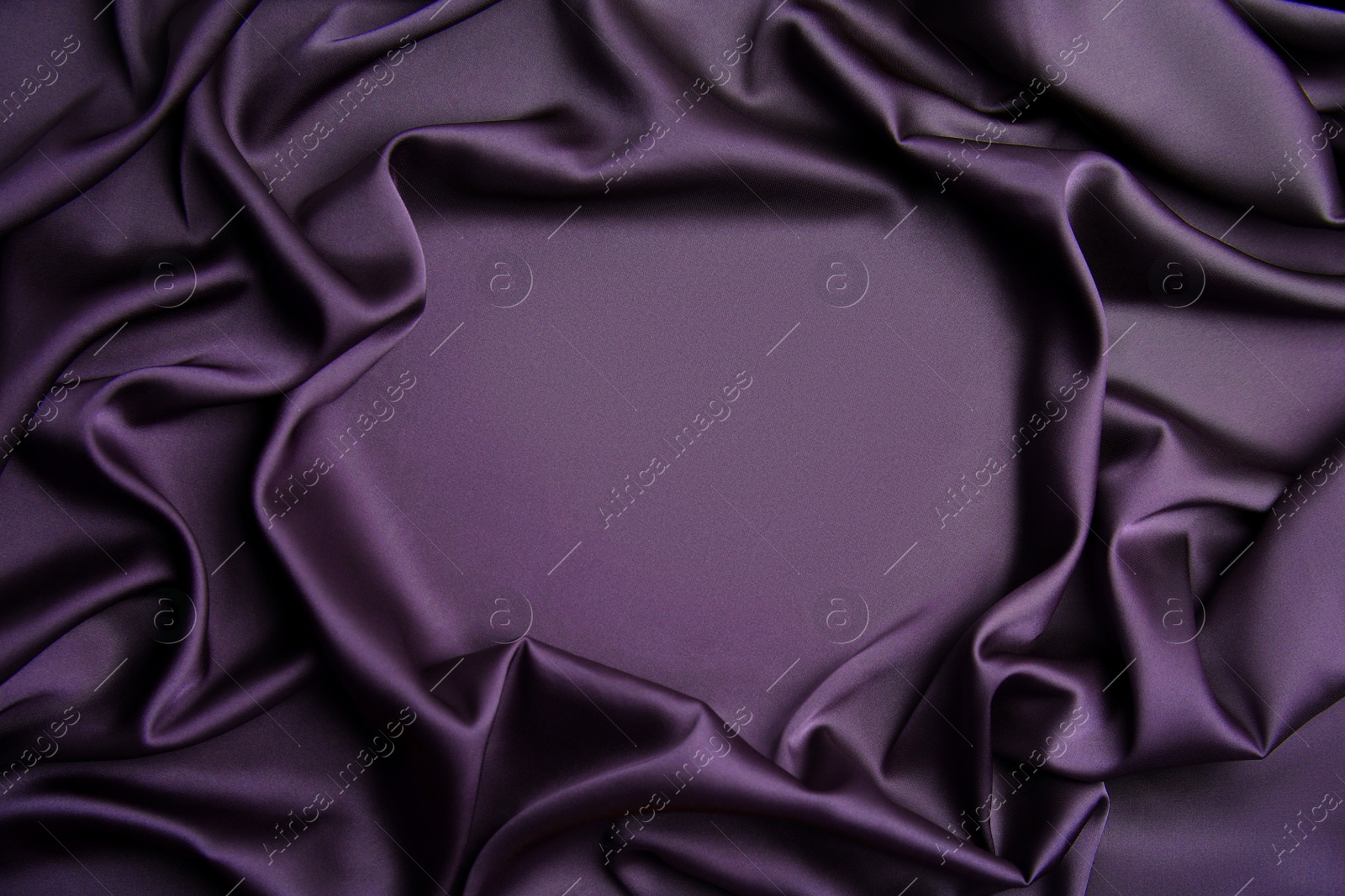 Image of Delicate dark violet silk fabric as background, top view. Space for text