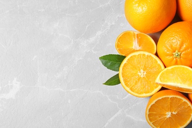 Flat lay composition with ripe oranges and space for text on light background