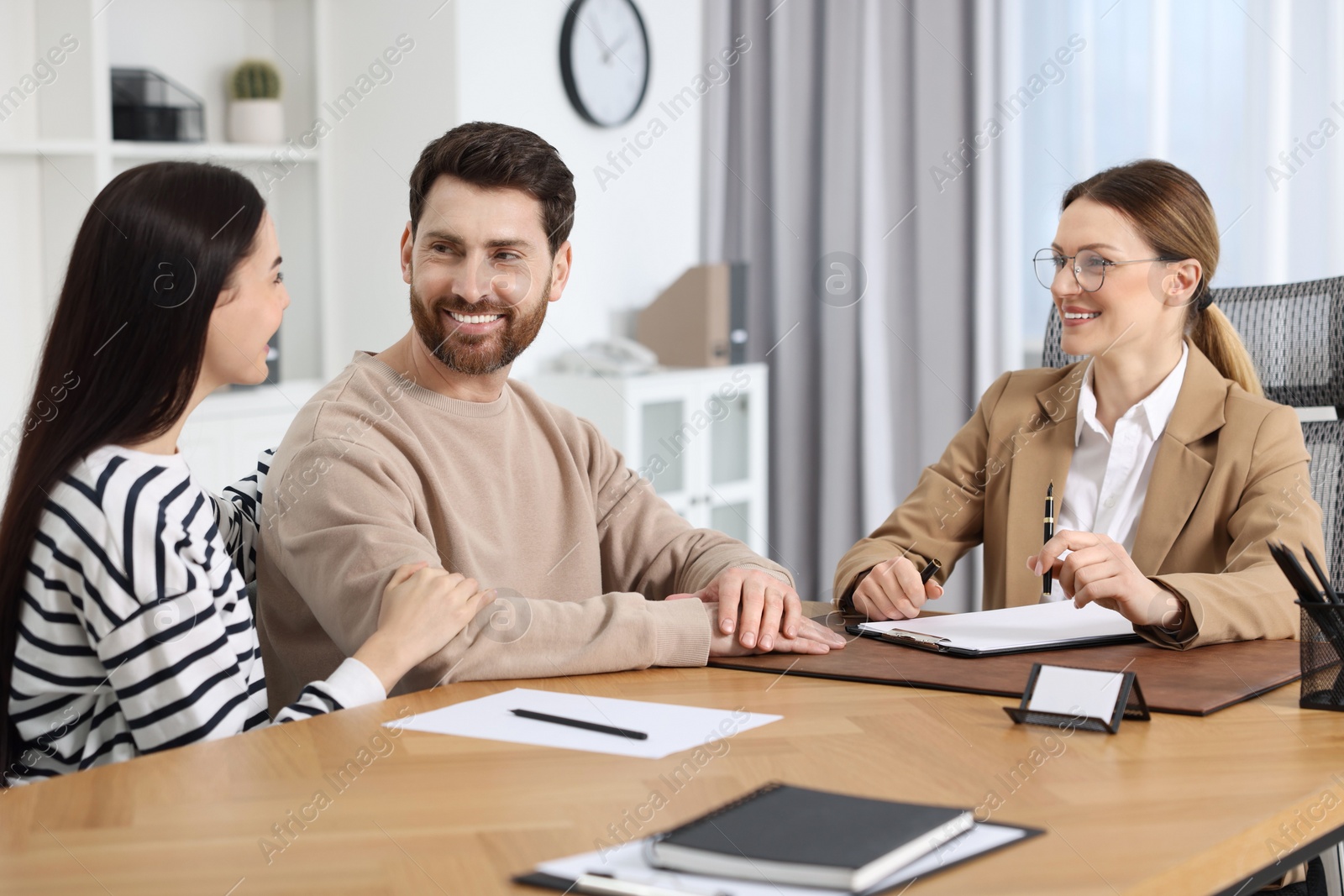 Photo of Couple having meeting with lawyer in office