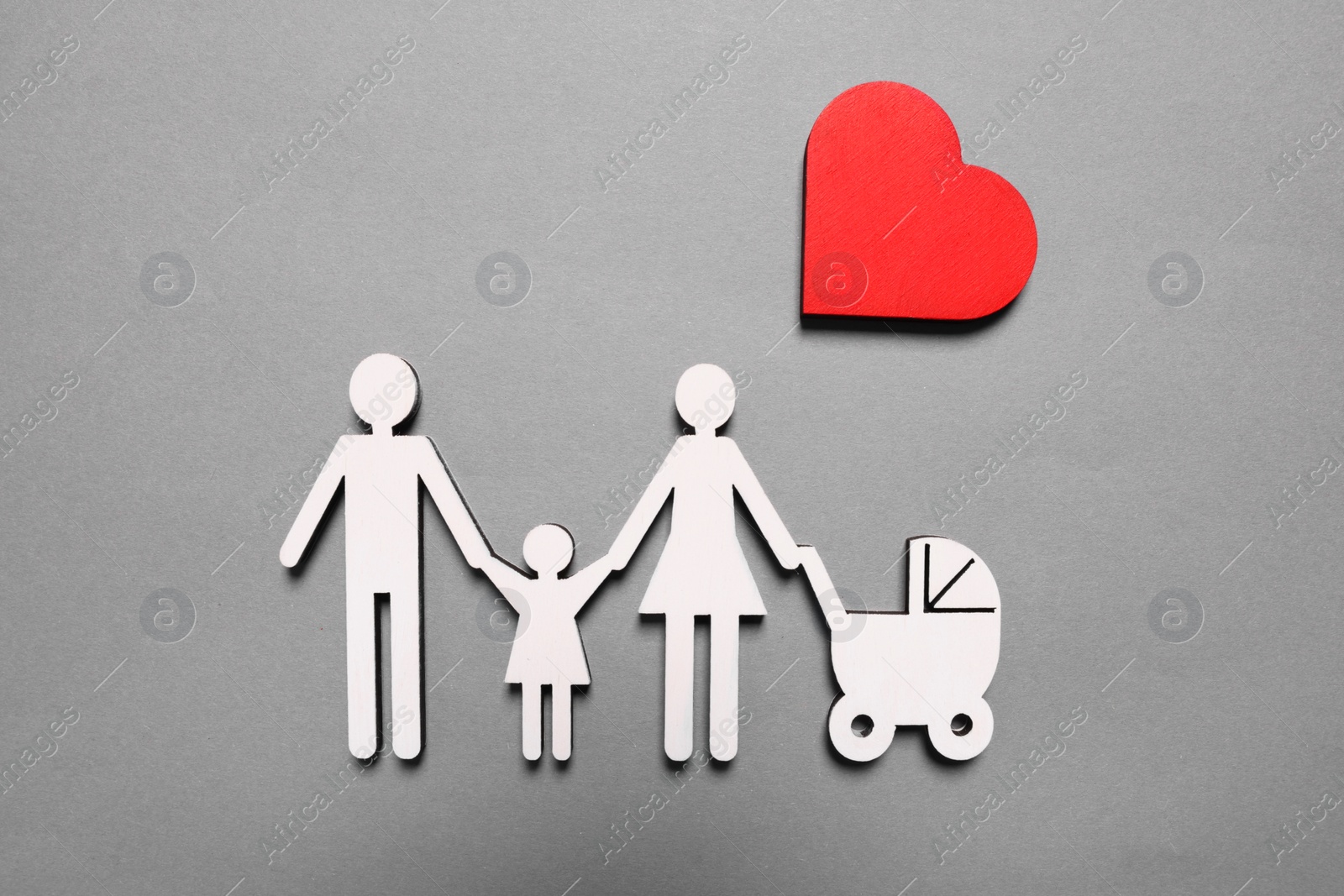 Photo of Figures of family under heart on lilac background, top view. Insurance concept