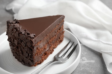 Delicious fresh chocolate cake served on grey table, closeup