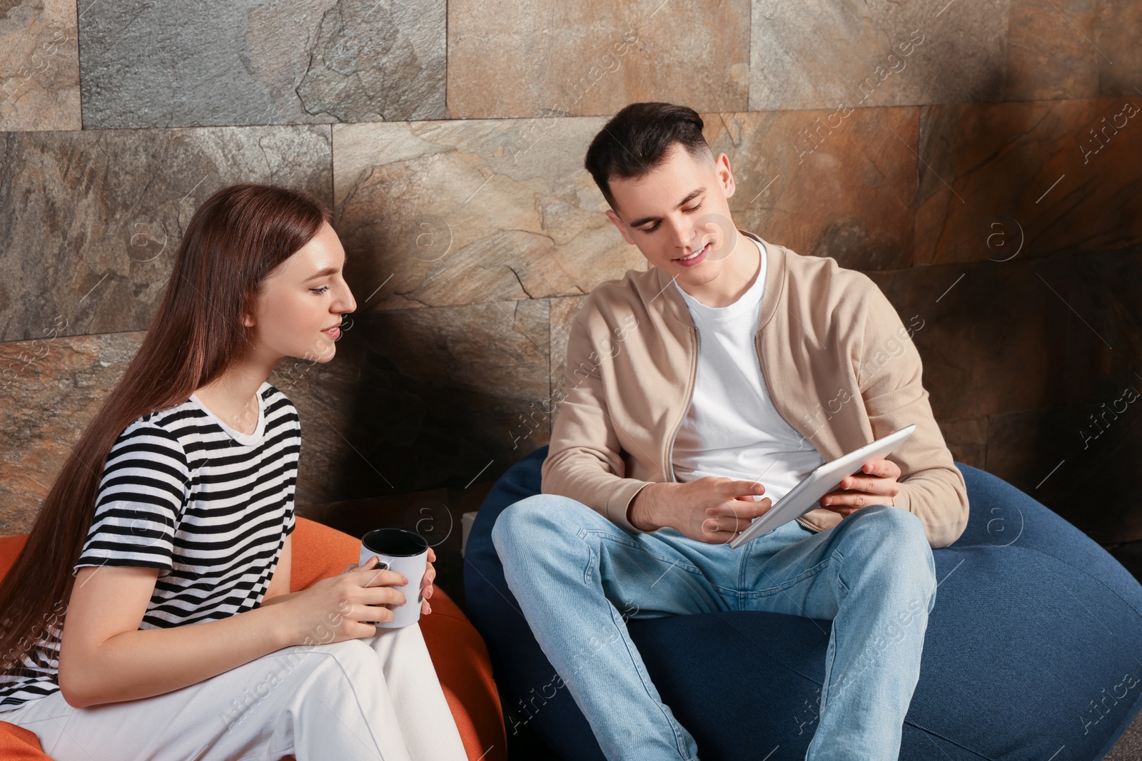 Photo of Office employees enjoying break together in recreation room at work