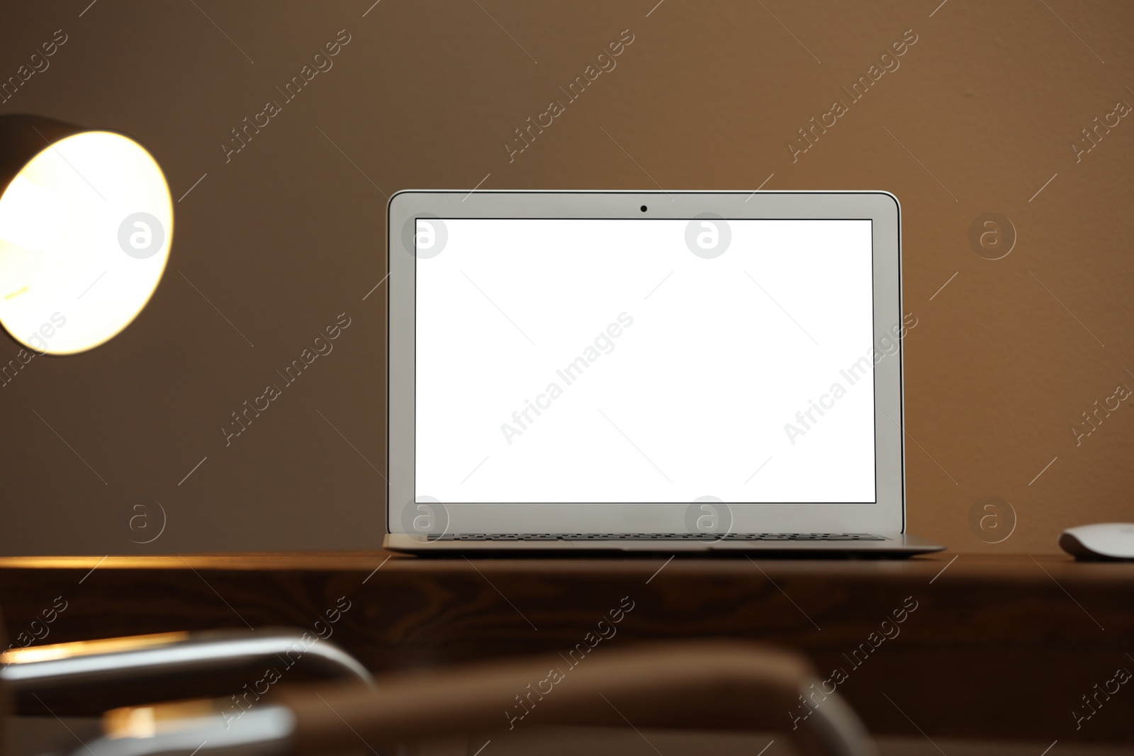 Photo of Laptop with blank screen on table indoors. Space for text