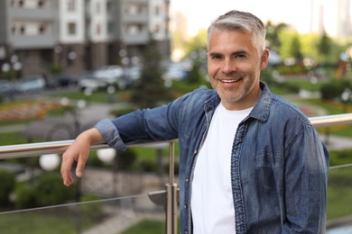 Portrait of handsome mature man in city center